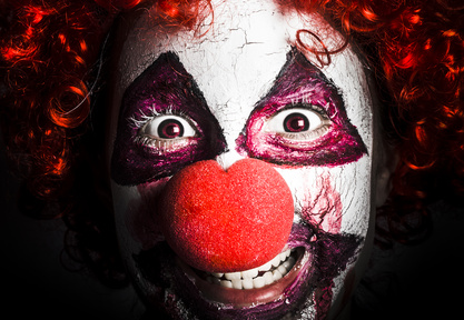 scary and evil clown smiling in dark spooky style